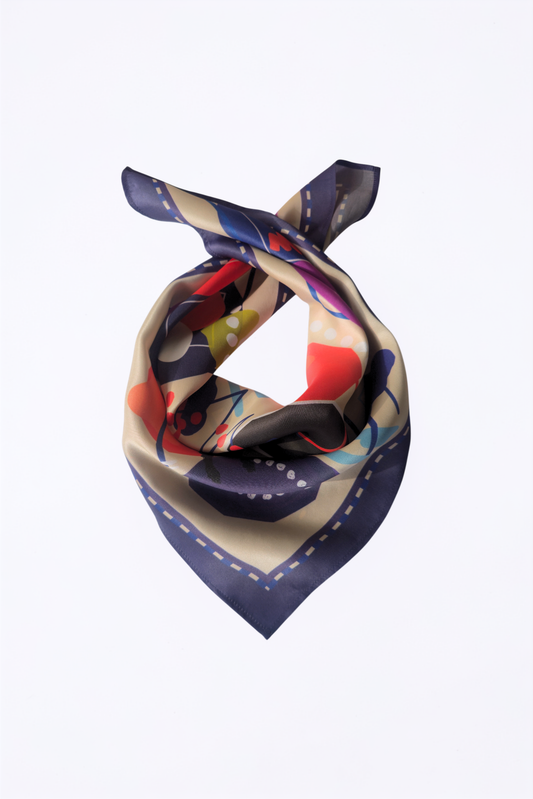 A square silk scarf with an abstract pattern, tied in a knot against a plain white background. The scarf features a navy blue border and a multicolor interior with beige, red, blue, and yellow shapes.