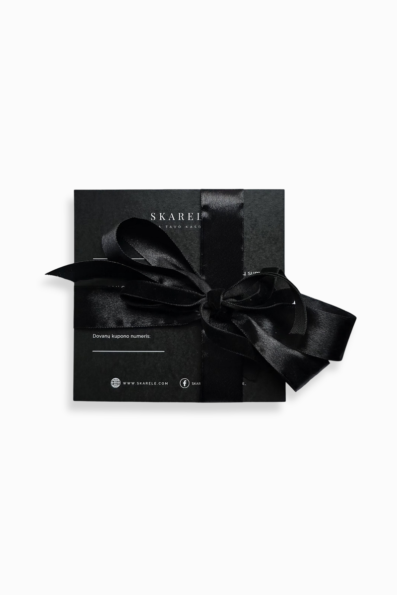 An elegant black square gift card tied with a wide black satin ribbon. Subtle white text and a logo are visible on the lid, creating a luxurious and minimalist look against a clean white background.