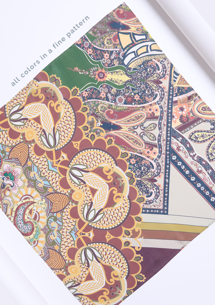 A fragment of a silk scarf featuring a highly detailed and colorful bohemian pattern. The design intertwines oriental paisley motifs, stylized flowers, and ornaments, harmoniously combining rich green, burgundy, mustard, and cream tones. The text "all colors in a fine pattern" in the photo highlights the intricacy of the print and the elegance and high quality of the accessory.