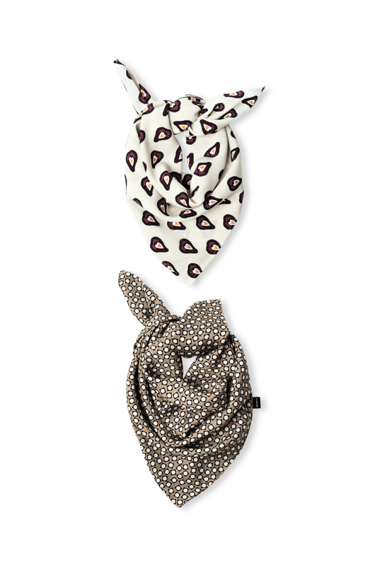 Two patterned viscose scarves artfully knotted on a white background: one featuring a cream base with dark heart shapes, and another in a taupe shade with a white geometric circle print.