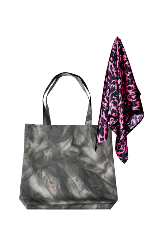 A set of grey water repellent cotton tote bag with a pink and black patterned silk scarf on a white background
