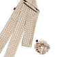 A matching silk accessory set featuring a long skinny twilly scarf and a mid-size scrunchie with a neutral rattan cane weave pattern on a white background.
