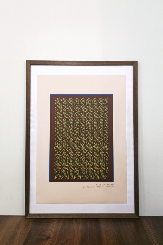 Interior mockup of the beige digital art print framed in a thin dark wooden frame with a white passe-partout mat, featuring green tea cups and leaves pattern, resting on a wooden table against a clean white wall