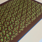 Perspective view close-up of the beige digital art print, highlighting the high-quality print finish, dark brown center with green tea cups and leaves, blue border line, and wooden frame edge