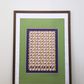 interior mockup of the "Movement citrus yellow" digital poster framed in a thin dark wooden frame with a white passe-partout mat, featuring padel rackets and  balls pattern, resting on a wooden table against a clean white wall.