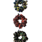 Three patterned silk scrunchies on a white background