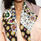 Woman wearing a colorful patterned viscose scarf on a plain background