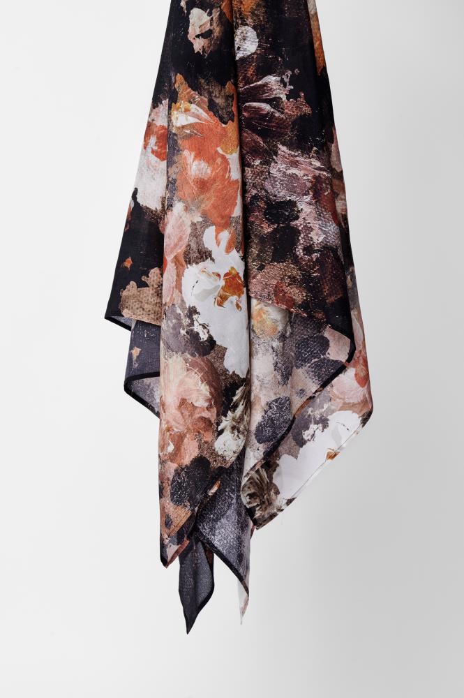 Hanging abstract scarf with a bold, textured pattern in warm tones of black, orange, and white against a plain white background.