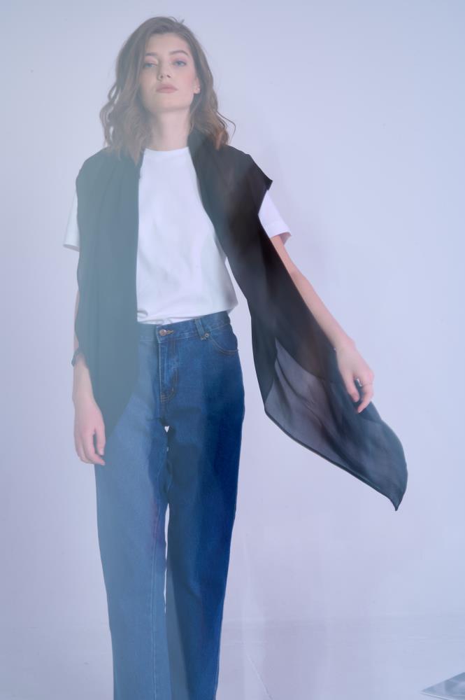 Woman wearing a white tee and jeans, effortlessly draped with a sheer black maxi silk scarf, creating a chic, lightweight casual look.