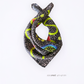 Tied Skarele La Dolce Vita viscose & silk blend scarf in small size (47 x 47 cm). Features a dark charcoal-brown dotted pattern with lime green wavy lines and lemon details, isolated on a white background