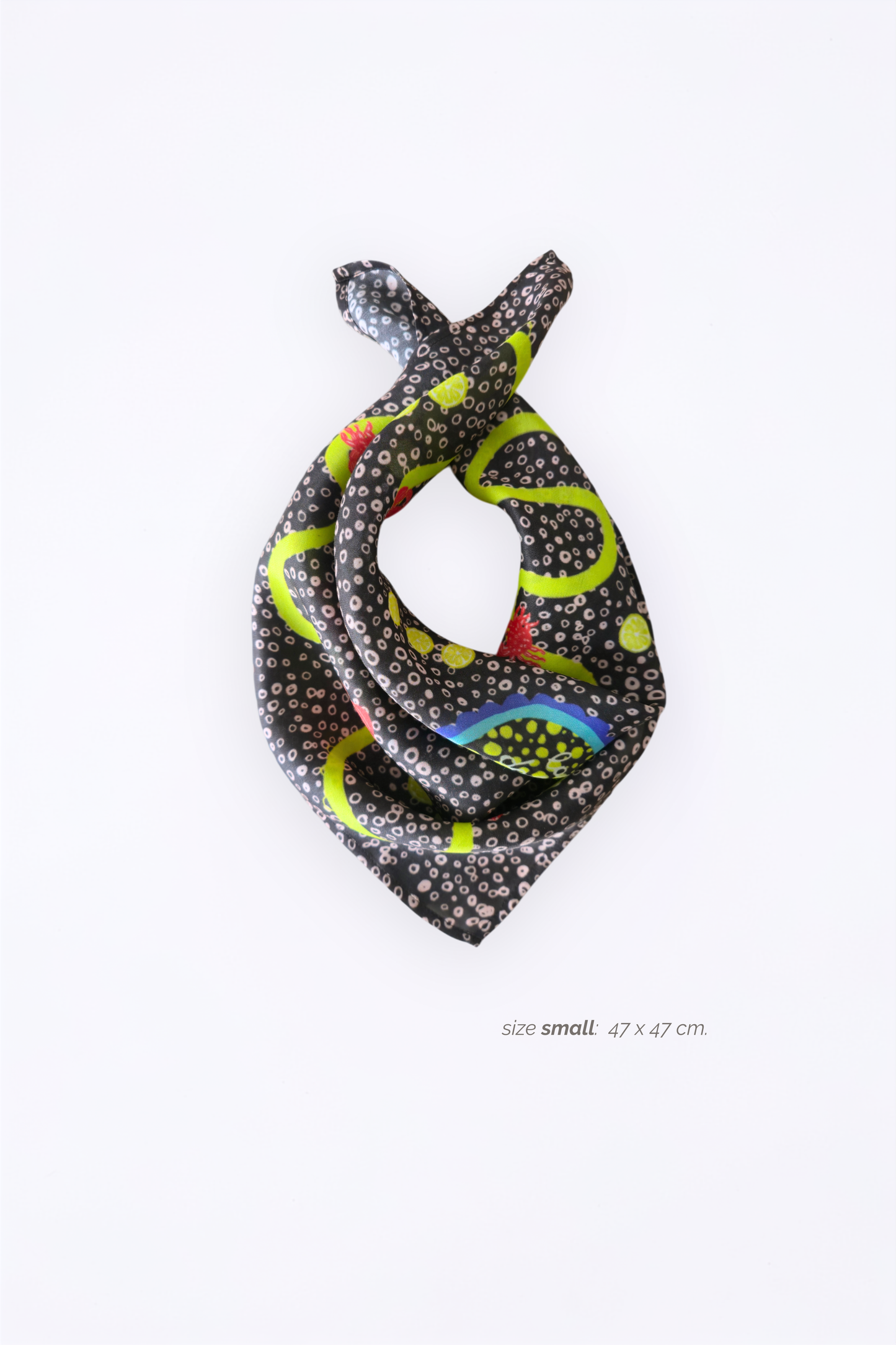 Tied Skarele La Dolce Vita viscose & silk blend scarf in small size (47 x 47 cm). Features a dark charcoal-brown dotted pattern with lime green wavy lines and lemon details, isolated on a white background
