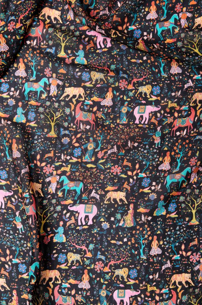 Dark silk fabric with colorful, intricate patterns featuring animals such as elephants, horses, tigers, and trees. Accents of vibrant pink, blue, and yellow create a lively and whimsical forest scene.