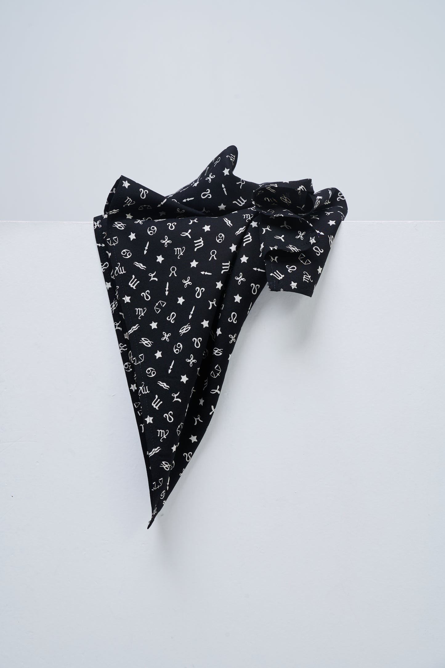 Black fabric with white patterns on a white background