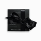 Sophisticated black packaging with a bow, symbolizing the luxury gift experience of a SKARELE electronic gift card for silk accessories.