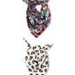Two patterned viscose neck scarves artfully knotted on a white background: one featuring a rich, colorful paisley pattern and another with a minimalist cream base and dark abstract heart motifs.