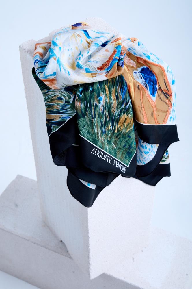 Close-up display of an artistic designer scarf with a masterpiece painting motif, showcasing the high-quality silk fabric's soft drape and detailed print against a minimalist studio background.