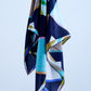 A multicolored abstract silk scarf with rolled and tucked edges, predominantly featuring shades of blue and green.