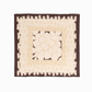 Full view flat lay display of the "Traces" square silk scarf, featuring a dark brown border, cream geometric inner frame, and a central stone-pavement mosaic pattern on a plain white studio background.