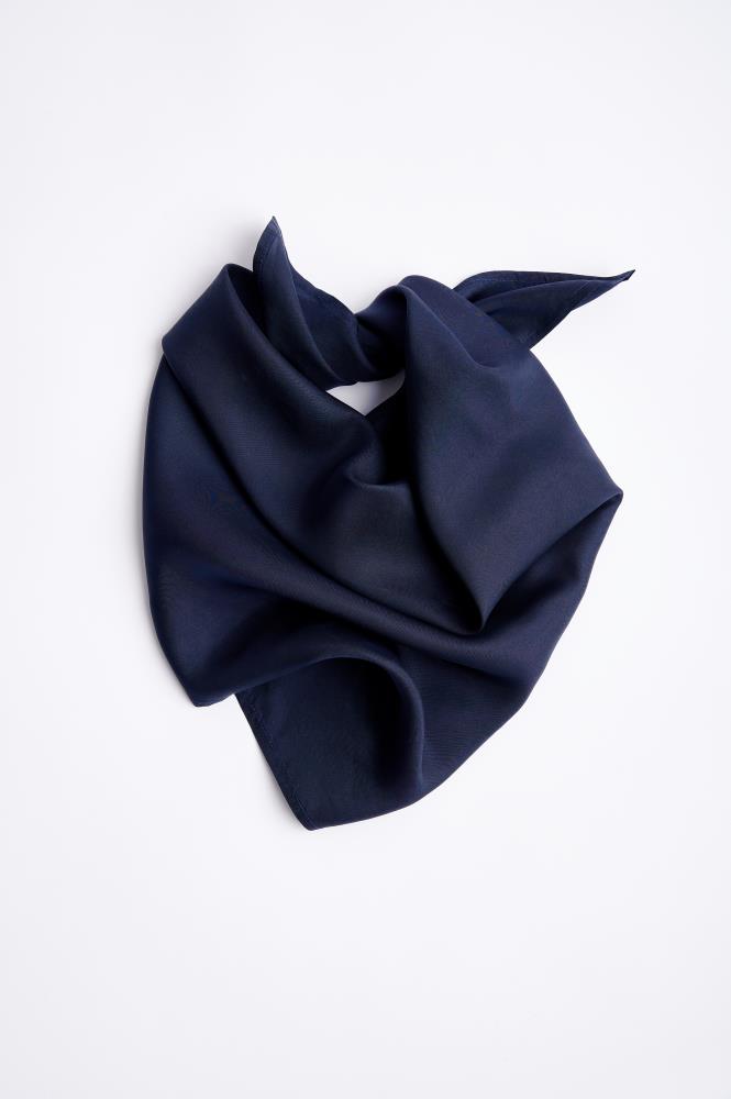 Navy blue silk scarf, minimalist studio product photography on a clean white backdrop, perfect for elegant styling.