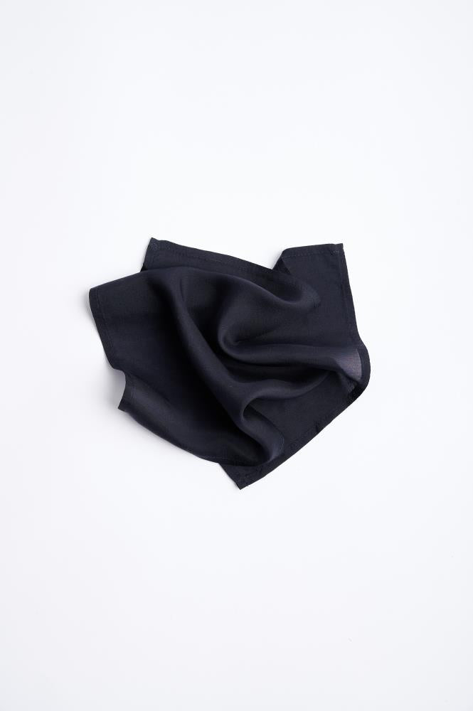 A black silk pocket square  folded neatly.