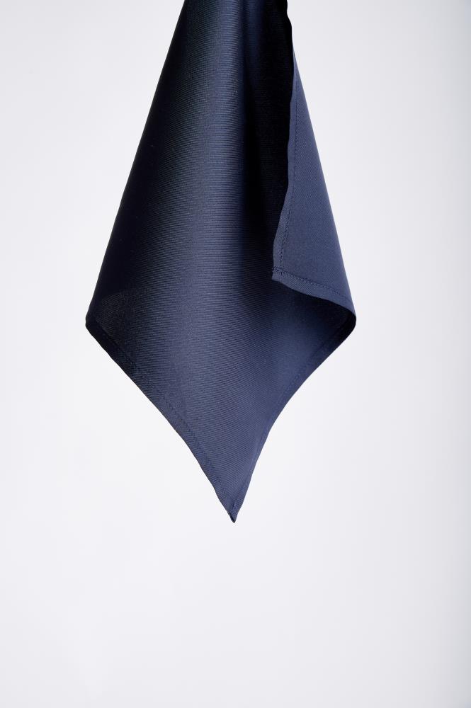A dark navy blue handkerchief hangs against a plain white background, showcasing its smooth texture and elegant, folded edges. Simple and refined.